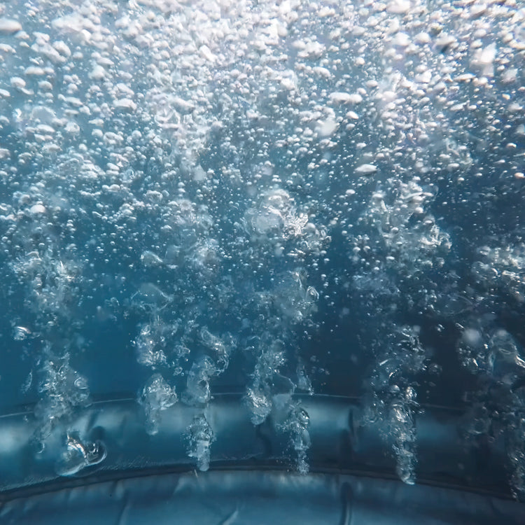 Underwater view of water jets bubbling.