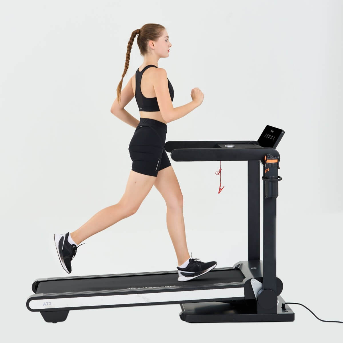 Woman running on treadmill at an incline.
